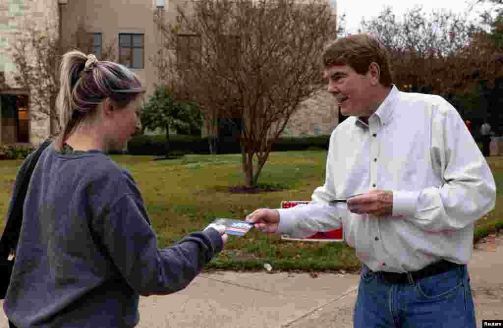 Austin City Council candidate Richard Smith greets a voter at Austin Oaks Church during the U.S. midterm elections in Austin, Texas, Nov. 8, 2022. 