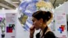 A participant walks past a mockup of the planet Earth globe at the Sharm el-Sheikh International Convention Centre, on the first day of the COP27 climate summit, in Egypt's Red Sea resort city of Sharm el-Sheikh, Nov. 6, 2022. 