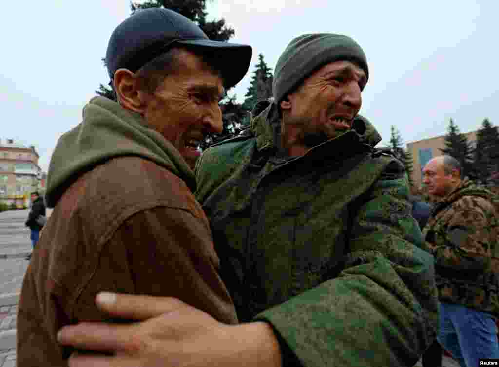 A serviceman hugs his brother after being released along with other military personnel from Russian-controlled parts of Donetsk and Luhansk regions in recent prisoner exchange in the town of Amvrosiivka (Amvrosievka),&nbsp;Donetsk region, Russian-controlled Ukraine.