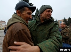 FILE - A serviceman hugs his brother after being released along with other military personnel from Russian-controlled parts of Donetsk and Luhansk regions in a prisoner exchange, in Amvrosiivka, Donetsk region, Russian-controlled Ukraine, on Nov. 6, 2022.