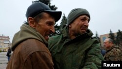 A serviceman hugs his brother after being released along with other military personnel from Russian-controlled parts of Donetsk and Luhansk regions in recent prisoner exchange in the town of Amvrosiivka (Amvrosievka),&nbsp;Donetsk region, Russian-controlled Ukraine.