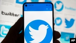 The Twitter logo is seen on a cell phone, Friday, Oct. 14, 2022, in Boston, Massachusetts. (AP Photo/Michael Dwyer)