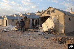 FILE - Shelling aftermath is seen in Maram camp in Idlib province, Syria, Nov. 6, 2022. Syrian government forces shelled tent settlements housing families displaced by the country's conflict.