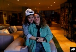 Saskia Nino de Rivera, right, a Mexican civil rights activist, and her girlfriend Mariel Duayhe, a sports agent for Mexican soccer players, pose for a photo at their apartment in Mexico City, Nov. 8, 2022.
