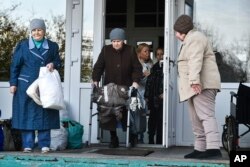 Elderly evacuees from Kherson leave their geriatric boarding house to move to the Crimea, southern Ukraine, Saturday, Nov. 5, 2022. (AP Photo)