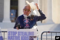 Native American demonstrators stood outside of the U.S. Supreme Court, as Justices heard arguments over the Indian Child Welfare Act, Wednesday, November 9, 2022 in Washington.