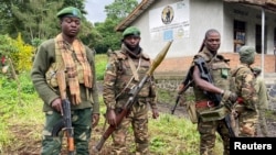 FILE - Armed Forces of the Democratic Republic of the Congo (FARDC) hold position following renewed fighting in Kilimanyoka, outside Goma in the North Kivu province of the Democratic Republic of Congo, June 9, 2022. 