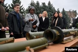 U.S. Ambassador to the United Nations Linda Thomas-Greenfield examines explosive ammunition and weapons as she visits the Forensic Center of the Ukrainian Ministry of Internal Affairs In Kyiv, Nov. 8, 2022.