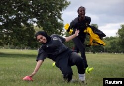 Yasmin Abdullahi (30), Pendiri Sisterhood FC, mengejar rekan setimnya Assma Asif (25), dalam sesi pelatihan di Hyde Park, di London, Inggris, 6 Juni 2021. (REUTERS/Hannah McKay CARI "MCKAY SISTERHOOD FC" )