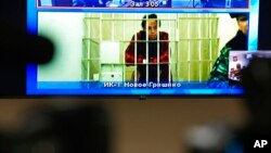 FILE - WNBA star and two-time Olympic gold medalist Brittney Griner is seen on the bottom part of a TV screen as she waits to appear in a video link provided by the Russian Federal Penitentiary Service at the Moscow Regional Court in Moscow, Russia, Oct. 25, 2022. 