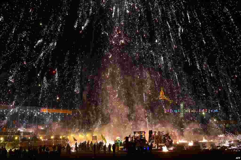 Fireworks explode after revelers released a hot-air balloon attached with fireworks during the Tazaungdaing Lighting Festival in Pyin Oo Lwin, Myanmar, Nov. 7, 2022.