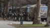 FILE - Russian army soldiers stand next to their trucks during a rally against Russia's occupation, in Svoboda (Freedom) Square in Kherson, Ukraine, March 7, 2022. Russia’s military announced Nov. 9, 2022, that it’s withdrawing from Kherson and nearby areas.