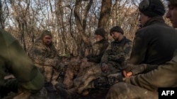 Ukrainian soldiers of an artillery unit rest outside Bakhmut on Nov. 8, 2022.