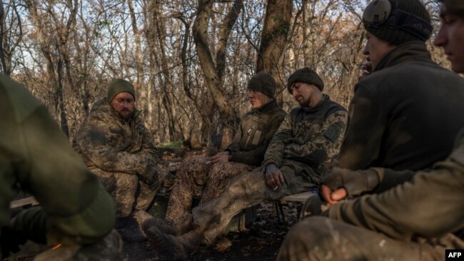 Ukrainian soldiers of an artillery unit rest outside Bakhmut on Nov. 8, 2022.