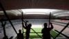 FILE - Laborers remove scaffolding at the Al Bayt stadium in Al Khor, Qatar, about 50 kilometers (30 miles) north of Doha, Apr. 29, 2019. 