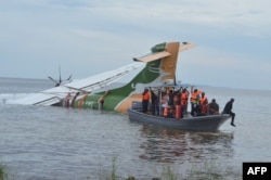 FILE - Rescuers search for survivors after a Precision Air flight that was carrying 43 people plunged into Lake Victoria as it attempted to land in the lakeside town of Bukoba, Tanzania, Nov. 6, 2022.