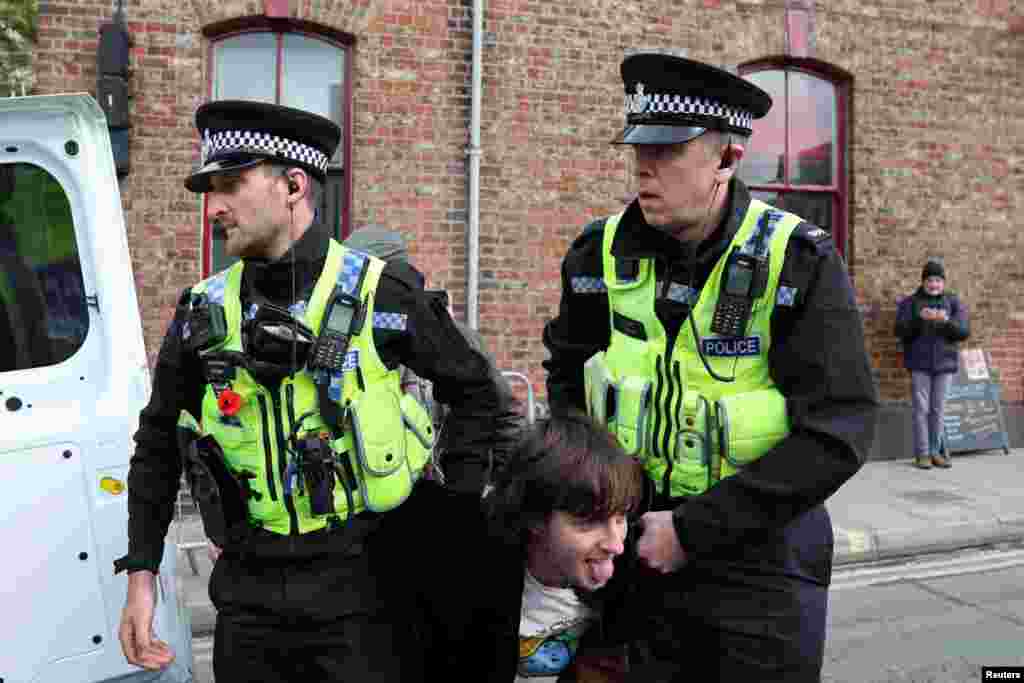 Police officers detain a man who threw an egg at King Charles during the king&#39;s visit to Micklegate bar in York, England.