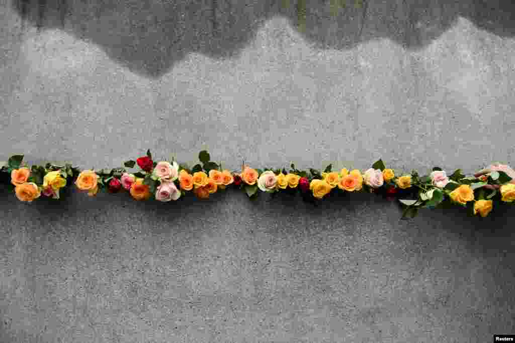 A view of roses placed by people on the day of a memorial ceremony marking the 33rd anniversary of the fall of the Berlin Wall at Bernauer Strasse in Berlin, Germany.