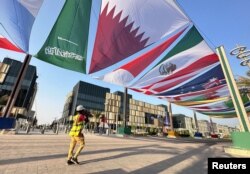FILE - Country flags are seen along a street in Lusail, Qatar, Oct. 22, 2022.