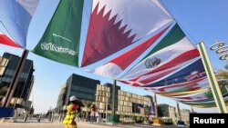 FILE - Country flags are seen along a street in Lusail, Qatar, Oct. 22, 2022.