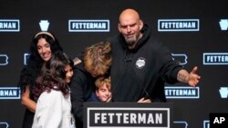 Pennsylvania Lt. Gov. John Fetterman, Democratic candidate for U.S. Senate from Pennsylvania, right, is joined by his family after addressing supporters at an election night party in Pittsburgh, Nov. 9, 2022.