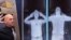 This file combination of images taken on October 13, 2009 shows an airport staff member (L) demonstrating a full body scan at Manchester Airport in Manchester, England