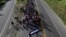Central American migrants, part of a caravan trying to reach the U.S., walk along the road as they continue their journey, in Ciudad Hidalgo, Mexico, Oct. 26, 2018. 