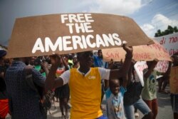 FILE - People protest for the release of kidnapped missionaries near the Ohio-based Christian Aid Ministries headquarters in Titanyen, north of Port-au-Prince, Haiti, Oct. 19, 2021.