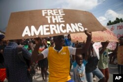 FILE - People protest for the release of kidnapped missionaries near the Ohio-based Christian Aid Ministries headquarters in Titanyen, north of Port-au-Prince, Haiti, Oct. 19, 2021.