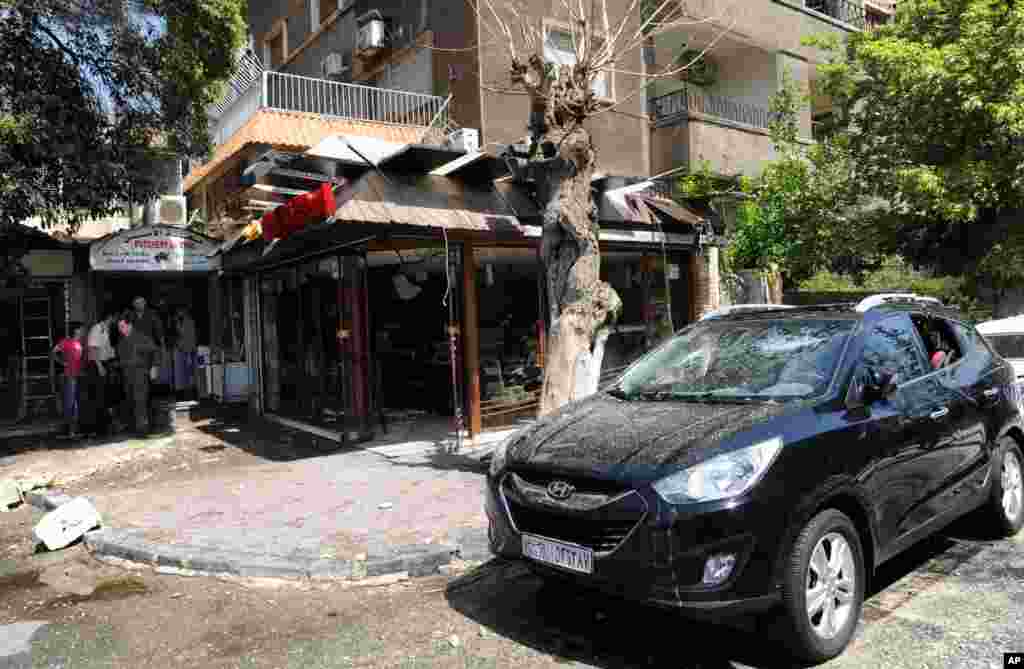 This photo released by the Syrian official news agency SANA shows a building damaged by what SANA said was a missile in Damascus, Sept. 2, 2013.