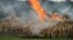 Ivory piles begin to burn at Nairobi National Park, Kenya, April 30, 2016. 105 tons of elephant ivory and more than 1 ton of rhino horn were destroyed in a bid to help stamp out the illegal ivory trade.  