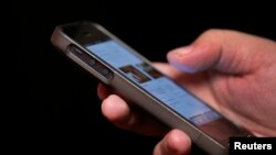 A man uses a smartphone in New York City, in this picture taken November 6, 2013. Twitter Inc raised the top end of its IPO price range by 25 percent and will close its books a day early, signaling strong demand for the most closely watched Silicon Valle