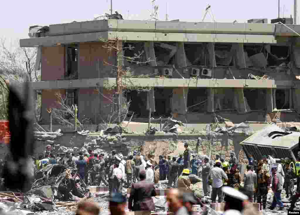 Afghan officials inspect outside the German embassy after a blast in Kabul, Afghanistan, May 31, 2017.