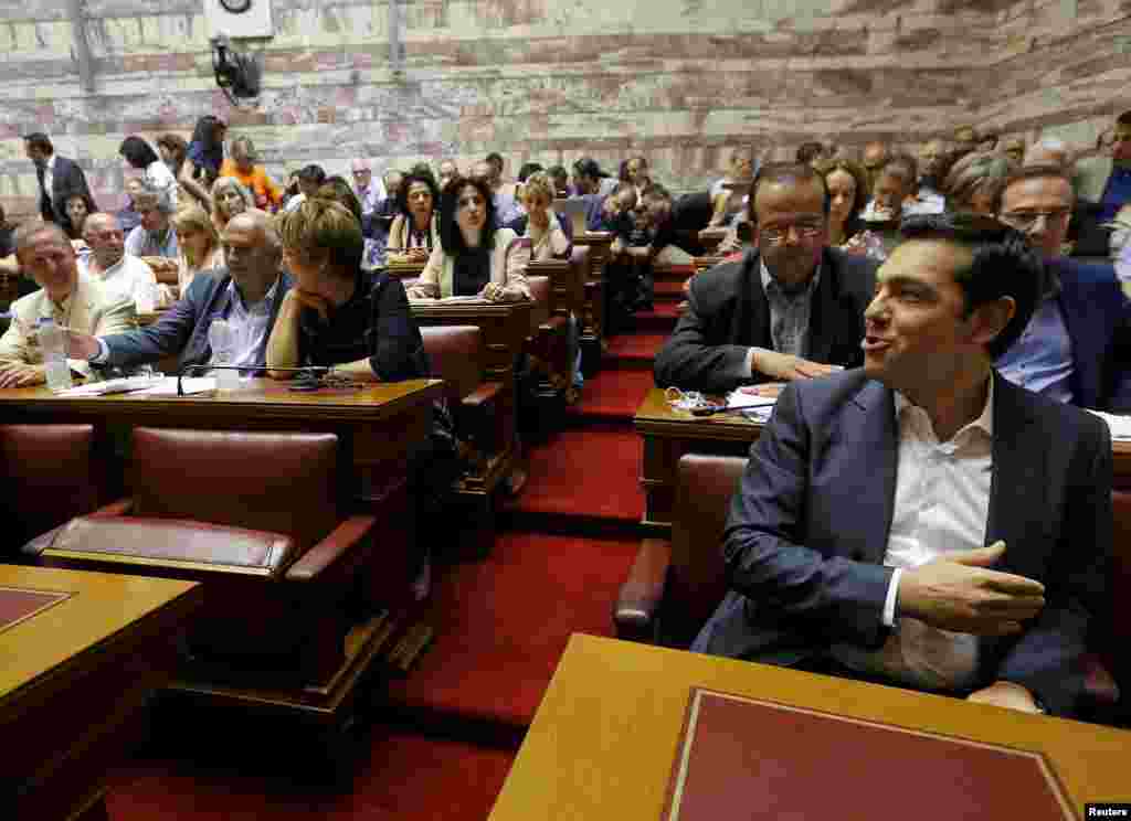 Greek Prime Minister Alexis Tsipras (R) is seen before a ruling Syriza party parliamentary group session in Athens, July 15, 2015.