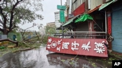 A fallen sign lies on the pavement as as Typhoon Krathon makes landfall in Kaohsiung, southern Taiwan, Oct. 3, 2024.