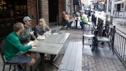 FILE - People dine outside The Corner Alley during the coronavirus pandemic, May 15, 2020, in Cleveland. Republican Ohio Gov. Mike DeWine had said 90% of the state's economy would be back online over this past weekend.