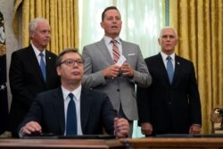 President Donald Trump’s special envoy on Serbia and Kosovo Richard Grenell speaks during a signing ceremony, with Serbian President Aleksandar Vucic sitting at a desk in the Oval Office of the White House in Washington, Sept. 4, 2020.