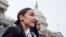 FILE - Rep. Alexandria Ocasio-Cortez, left, and D-N.Y., Rep. Ilhan Omar, D-Minn., center, walk down the House steps to take a group photograph of the House Democratic women members of the 116th Congress on the East Front Capitol Plaza on Capitol Hill.
