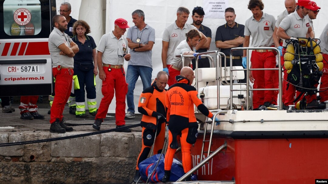 Ronioci iznose telo Majka Linča (Foto: REUTERS/Guglielmo Mangiapane)
