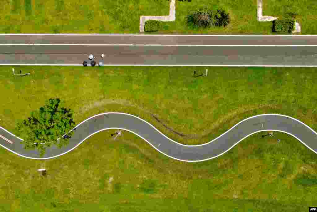 This image from above shows local people walking at a park in Taipei, Taiwan. (Photo by Sam Yeh / AFP)