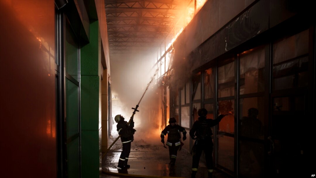 Firefighters work to extinguish a fire at a shop following a Russian bombardment in Kharkiv, Ukraine, April 22, 2022.