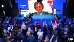 President of the liberal Freedom Movement party Robert Golob (on screen, via videocall, due to a positive COVID test) addresses member of his party after exit poll results gave them the victory in Slovenia's parliamentary elections, in Ljubljana, April 24