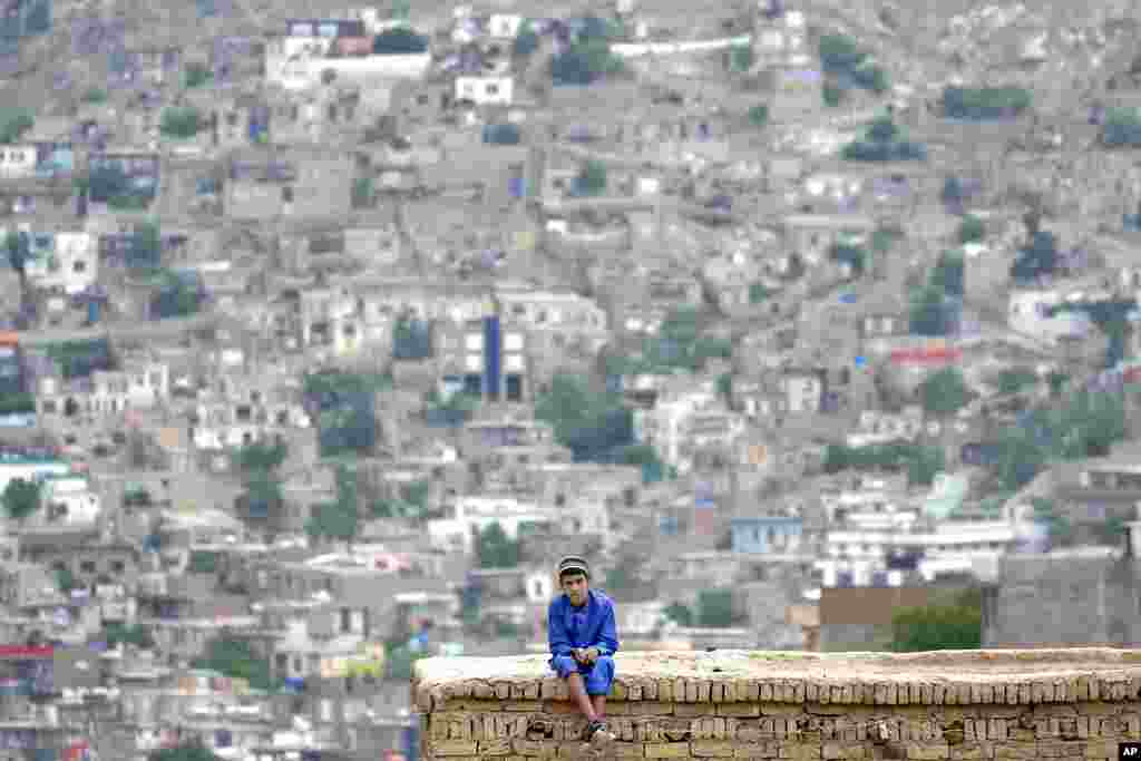 A child sits on the roof of his house in Kabul, Afghanistan.