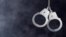 Handcuffs hanging on dark
