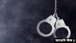 Handcuffs hanging on dark