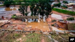 FILE - A collapsed bridge is seen on the Griffiths Mxenge Highway after flooding, in Durban, South Africa, April 13, 2022.