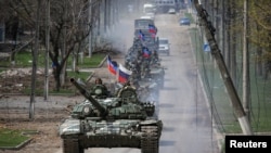 An armored convoy of pro-Russian troops moves along a road during Ukraine-Russia conflict in the southern port city of Mariupol, Ukraine April 21, 2022. 