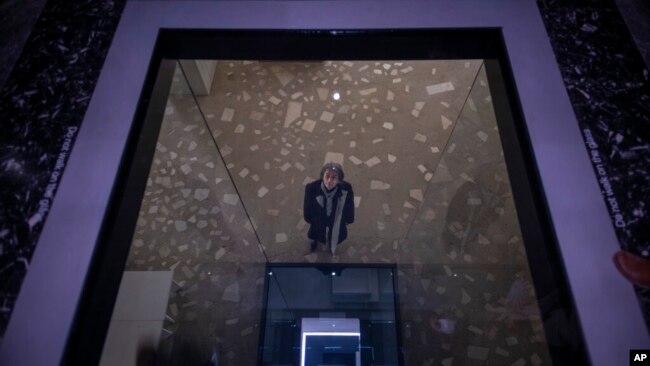Satoshi Hama, a member of the artistic collective Dumb Type, is seen through a hole in the floor of the Japanese pavilion at the 59th Venice Biennale Of The Arts in Venice, Italy, April 21, 2022.