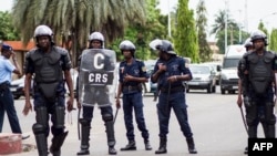 La police anti-émeute béninoise monte la garde dans la rue alors qu'une foule de partisans de l'homme d'affaires et ancien candidat à la présidentielle Sébastien Ajavon manifeste à Cotonou le 31 octobre 2016.