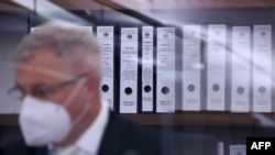 Files are pictured in the courtroom before the start of the trial against Gambian defendant Bai Lowe, accused of of crimes against humanity, murder and attempted murder, on April 25, 2022 in Celle, northern Germany.